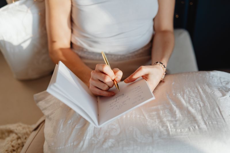 a woman writing something on her notebook